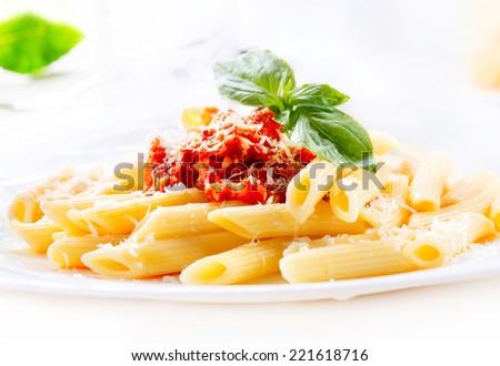 Pasta. Penne Pasta with Bolognese Sauce, Parmesan Cheese and Basil. Italian Cuisine. Mediterranean food