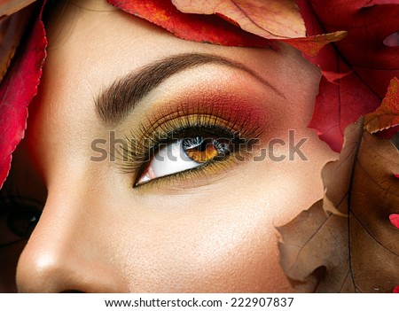 Autumn make up for brown eyes. Closeup fashion makeup. Perfect face skin, autumn warm colors of eyeshadows, long eyelashes.