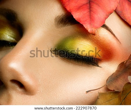 Autumn eye make-up. Closeup fashion makeup. Perfect face skin, colorful autumn eyeshadows, long eyelashes