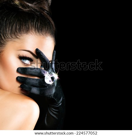 Beauty Fashion Glamorous Model Girl Portrait. Vintage Style Mysterious Woman Wearing black Glamour Gloves. Jewellery. Jewelry. Holiday Hairstyle and Make-up. Diamond Ring. Retro Lady with Blue Eyes