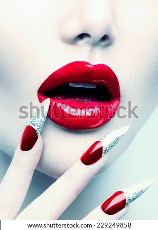 Makeup and Manicure. Red Long Nails and Red Glossy Lips. Sensual Mouth. Nail Art. Beautiful Sexy Lips. Fashion Model Woman Face. Professional Make-up. Perfect Skin