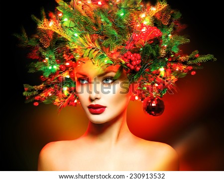Christmas Winter Fashion Model Girl with Christmas tree hairstyle decorated with garland lights and baubles. make up. Beauty Woman. Beautiful New Year Holiday Creative Hair style