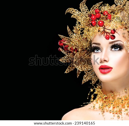 Christmas Winter Fashion Model Girl with golden hairstyle and make up. Beauty Woman. Beautiful New Year Holiday Creative Hair style decorated with Baubles. Lady face isolated on black Background
