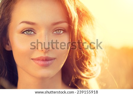 Beauty Fresh Romantic Girl Outdoors. Nature. Sunset. Beautiful Model young Woman face close up. Cute Teenage Girl on the Field Smiling in Sun Light. Glow Sun, Sunshine. Backlit