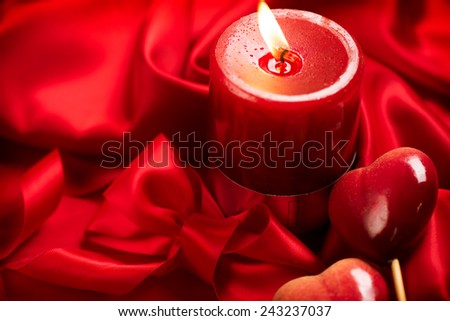 Valentine\'s Day. Valentine Red Hearts and red candles on Red Silk Background
