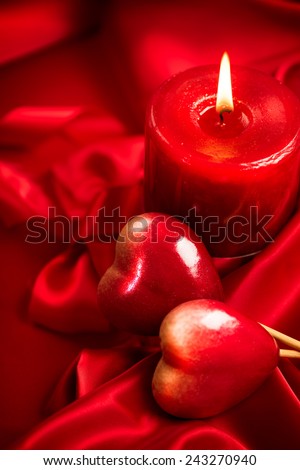 Valentine\'s Day. Valentine Red Hearts and candle on Red Silk Background. Beautiful Valentine card art design
