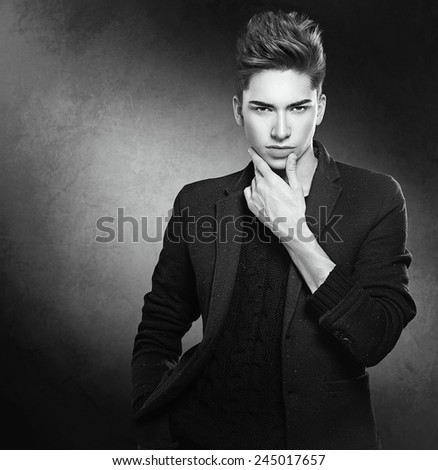 Fashion young model man portrait. Handsome Guy. Vogue style image of elegant young man. Studio fashion black and white portrait.