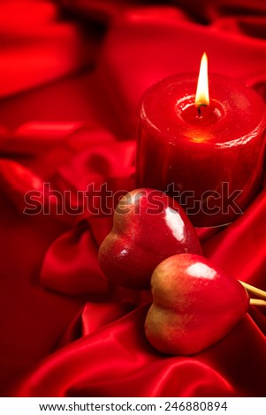 Valentine\'s Day. Valentine Red Hearts and candle on Red Silk Background. Beautiful Valentine card art design