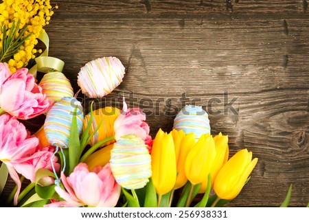 Easter Background. Beautiful Easter holiday backdrop frame decorated with colourful eggs and tulip flowers. Springtime
