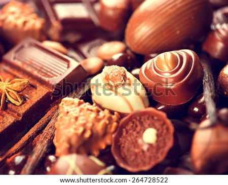 Chocolates background. Chocolate. Assortment of fine chocolates in white, dark, and milk chocolate. Variety of Praline Chocolate sweets