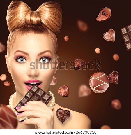 Beauty fashion model girl eating chocolate. Beautiful Surprised young woman takes chocolate sweets. Funny girl, professional make up and bow hairstyle. Diet,dieting concept