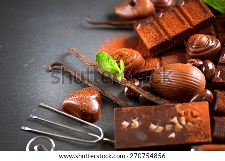 Chocolates background. Chocolate. Assortment of fine chocolates in dark and milk chocolate with vanilla and mint. Praline Chocolate sweets