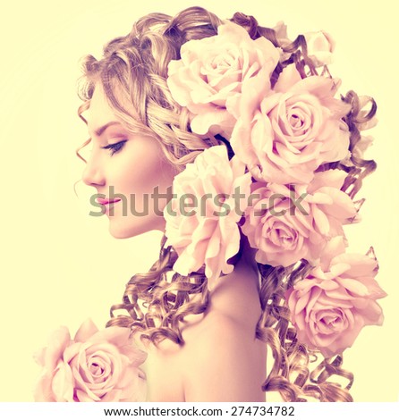 Beauty girl with rose flowers hairstyle isolated on white background. Fashion model  woman portrait with pink flowers. Summer fairy portrait. Long permed curly hair. Perfect make up