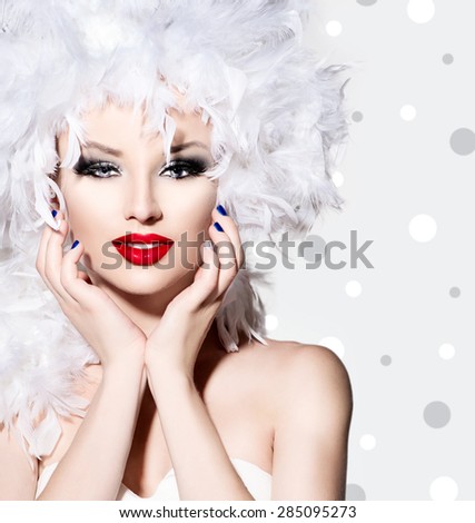Beauty Fashion Model Girl with White Feathers Hair style and bright make up. Beautiful woman with feathers on her head. Hairstyle. Holiday Creative Makeup and manicure. Polka dots background