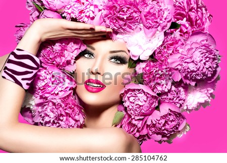 Beauty High Fashion Model Girl with pink Peony hair style. Vivid Make up. Beautiful Model woman with Blooming flowers on her head. Nature Hairstyle. Summer. Holiday Creative Makeup and manicure