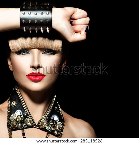 Beauty Punk Fashion Model Girl. Rocker Style Model Portrait. Fringe Hairstyle. Rocker or Punk Woman Makeup and Accessories. Isolated on black background