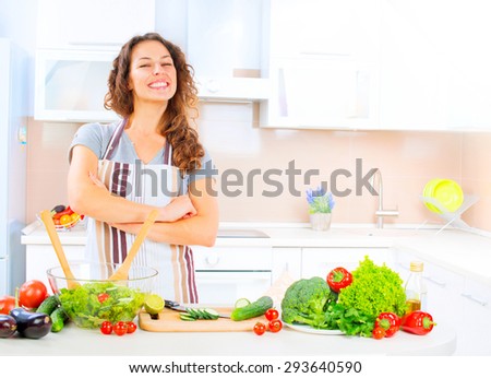 Happy Young Woman Cooking in the kitchen at home Healthy Food, Vegetable Salad. Diet. Dieting Concept. Healthy Lifestyle. Prepare Food. Slimming, weight loss