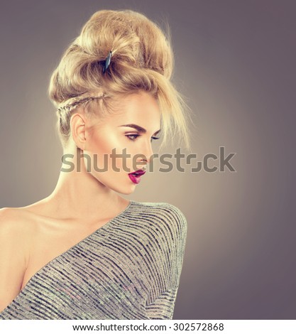 High Fashion Model Girl Portrait with Updo hair style. Beauty Woman with Modern Hairstyle and perfect glamour make up. Blonde hair. Beautiful blond lady headshot