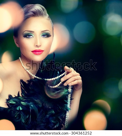 Beautiful Luxury Woman portrait. Beauty Lady with expensive accessories - pearls necklace over dark blurred background. Holiday dress and make up