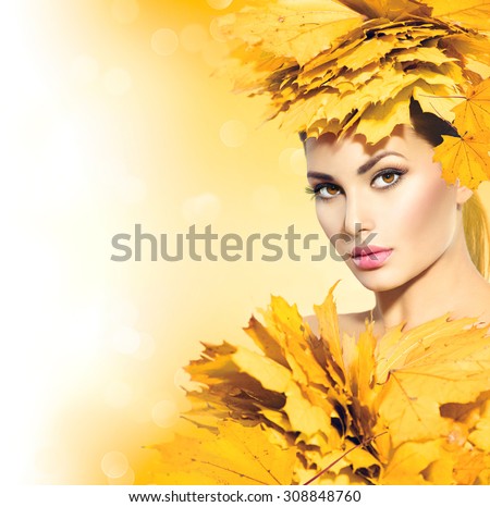 Autumn woman with yellow leaves hair style. Autumn Lady Portrait. Beauty Fashion Art Model Girl with Autumnal Make up and Hairstyle. Fall. Creative Autumn Makeup. Beautiful Face