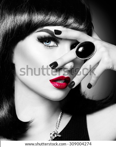 Beautiful mysterious brunette lady portrait. Beauty young woman with bob haircut, bright make up, red lips, smoky eyes makeup. Luxury accessories, ring. Black and white