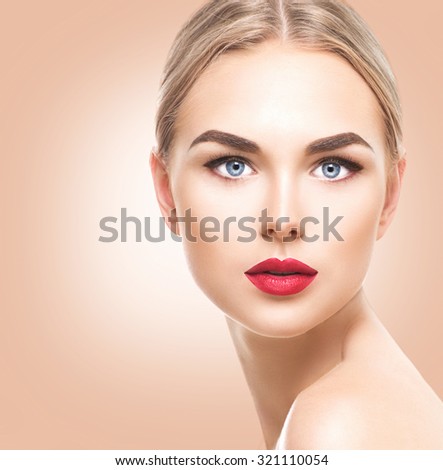 Attractive model girl face with perfect make-up looking at camera close up. Portrait of beauty young woman with blond hair and blue eyes. Beautiful female face with clear fresh skin. Pure Beauty model