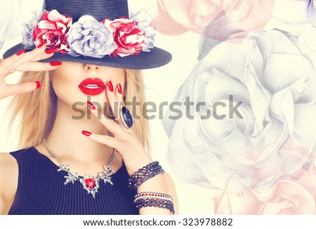 Beautiful sexy woman with red lips and manicure in modern black hat. Beauty fashion model girl with accessories- rings, bracelets, necklace and elegant hat decorated with flowers