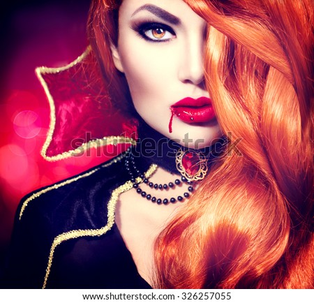 Halloween Vampire Woman portrait. Beautiful Glamour Fashion Sexy Vampire Lady with long red hair, beauty make up and costume