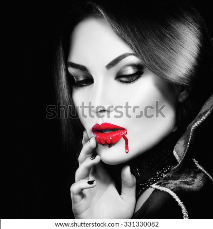 Vampire Halloween Woman portrait. Beauty Sexy Vampire Girl with  bripping blood on her mouth. Fashion Art design. Black and White photo of Attractive model girl in Halloween costume and make up