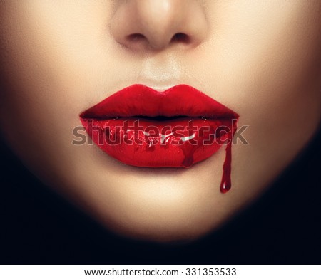 Sexy Vampire Woman lips with dripping blood. Fashion Glamour Halloween art design. Closeup of glamourous girl vampire mouth