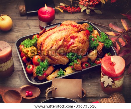Roasted Turkey. Thanksgiving Dinner. Thanksgiving table served with turkey, decorated with bright autumn leaves. Table setting with greeting card