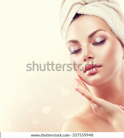 Spa Woman. Beautiful Girl After Bath Touching Her Face. Perfect Skin. Skincare. Young Skin. Cleansing