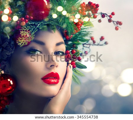 Christmas Makeup. Winter Fashion Woman. Beautiful New Year and Christmas Tree Holiday Hairstyle, Make up. Beauty Model Girl over glowing Background. Creative Hair style decorated with Baubles