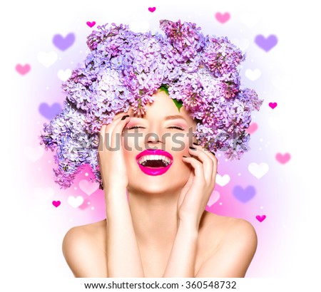 Beauty fashion model Girl with Lilac Flowers Hair Style. Beautiful Model woman with Blooming flowers on her head. Nature Hairstyle. Summer. Holiday Creative Makeup. Make up. Vogue Style