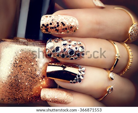 Golden Nail art manicure. Holiday style bright Manicure with gems and sparkles. Bottle of  Nail Polish. Fashion rings with diamonds, Trendy Accessories. Beauty hands. Stylish Nails, Nailpolish