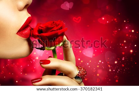 Valentines Day art design. Beautiful Model woman kissing red rose flower. Red Lips, Nails and Rose. Beauty Girl. Makeup and Manicure. Sensual Mouth. Sexy Red Color Lips. St. Valentine\'s Day design