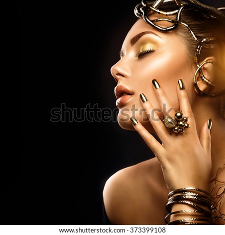 Beauty Fashion woman with Golden Makeup, accessories and nails. Girl Portrait with gold earrings, rings, bracelets and manicure closeup isolated on black background. Fashion art Hairstyle and make up