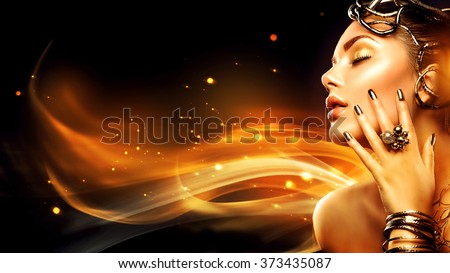 Burning woman head profile. Beauty Fashion model girl with Golden Makeup, accessories and nails on fire background. Gold earrings, rings, bracelets and manicure. Fashion art Hairstyle and make up
