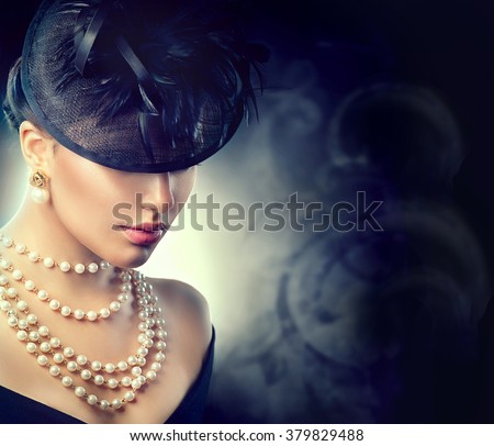 Retro Woman Portrait. Vintage Style Girl Wearing Old fashioned Hat, pearls necklace and earrings, retro Hairstyle and Make-up. Romantic lady over black background. Pearl Jewellery