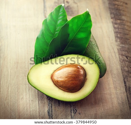 Avocado. Organic Avocados with leaves on a wooden table. Healthy Vegan food concept. Diet. Dieting