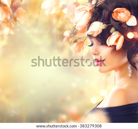 Spring Woman with flowers in her hair. Beauty Lady portrait Fashion Brunette Girl with Magnolia Flowers Hairstyle. Flowers in hair. Beautiful model girl with perfect make up