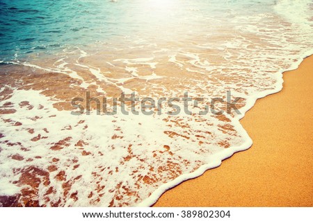 Beautiful sea summer abstract background. Golden sand beach with blue ocean waves Tourism and vacation concept. Beauty Backdrop