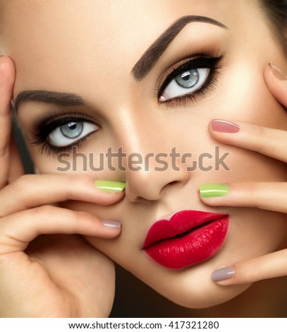 Beauty Fashion woman Portrait with Vivid Makeup and colorful Nail polish. Colourful nails. Beauty girl portrait close up. Bright Colors. Red lips, Manicure, Bright Make up. Smoky eyes, long eyelashes