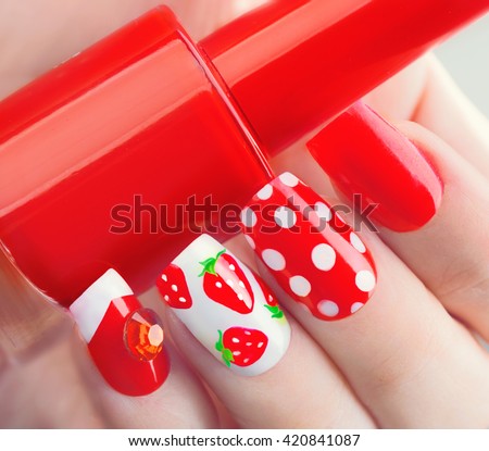 Nail art manicure. Summer bright Manicure with painted strawberries and polka dots. Bottle of Nail Polish. Beauty salon. Hand. Trendy Stylish Colorful Nails, Nailpolish