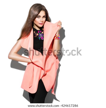 Fashion Model girl isolated over white background. Beauty stylish brunette woman posing in fashionable clothes in studio. Casual style with beauty accessories. High fashion urban style