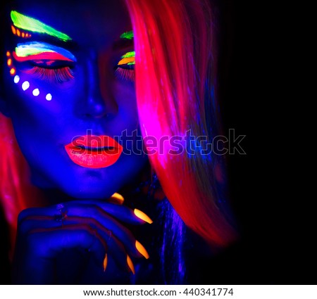 Fashion model woman in neon light, portrait of beautiful model girl with fluorescent make-up, Body Art design of female disco dancer posing in UV, painted face, colorful make up, over black background