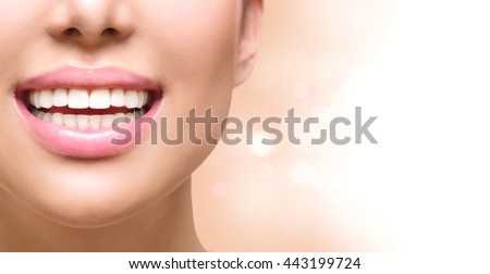Healthy Smile. Teeth Whitening. Dental care Concept. Woman Smile Closeup. Beautiful Lips and Teeth over white background