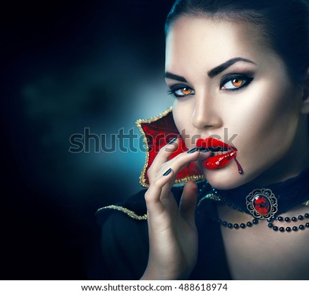 Vampire Halloween Woman portrait. Beauty Sexy Vampire Girl with dripping blood on her mouth. Vampire makeup Fashion Art design. Attractive model girl in Halloween costume and make up