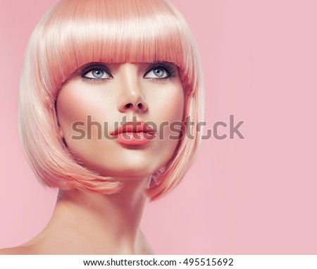 Beauty Fashion Model Portrait pink hair color. Bob Short Haircut. Fringe Hairstyle. Hairdressing. Beautiful Glamour Girl with Short blonde hair. Dyed hair, perfect makeup