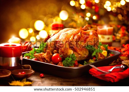 Thanksgiving dinner, Thanksgiving turkey. Served table. Thanksgiving table served with turkey, decorated with bright autumn leaves. Roasted turkey, table setting